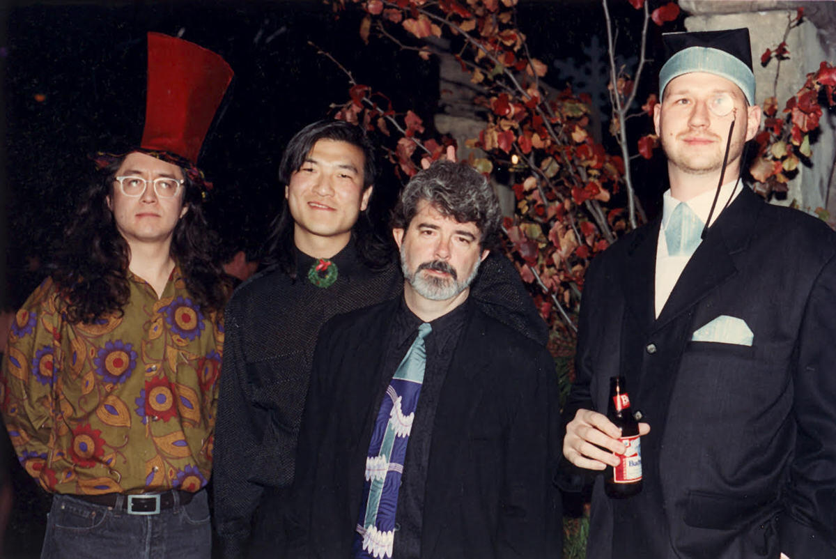 Four men standing next to eachother 