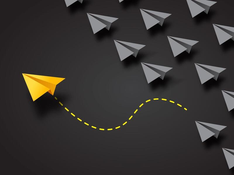 graphic of a yellow paper airplane breaking out from a crowd of other paper airplanes