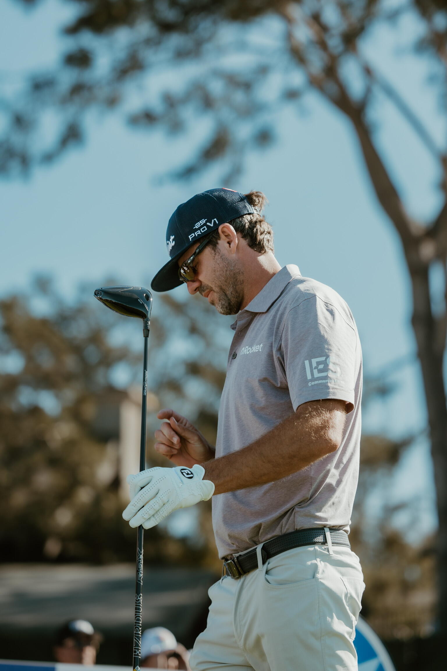 A photo of a man holding a golf club. 
