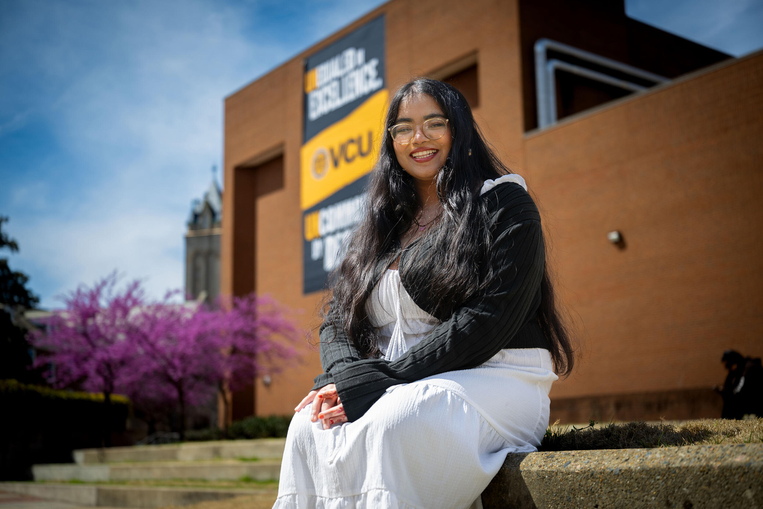 A photo of a woman sitting outside. 