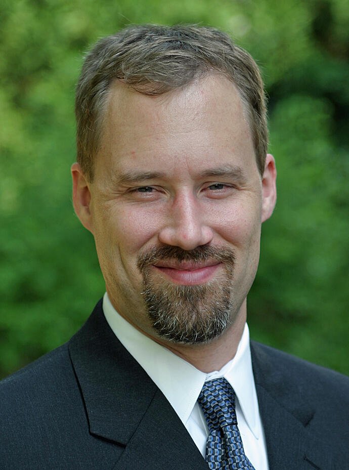 A photo of a man from the shoulders up. 