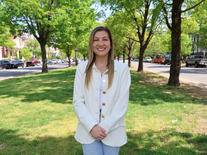 A photo of a woman standing from the knees up. 