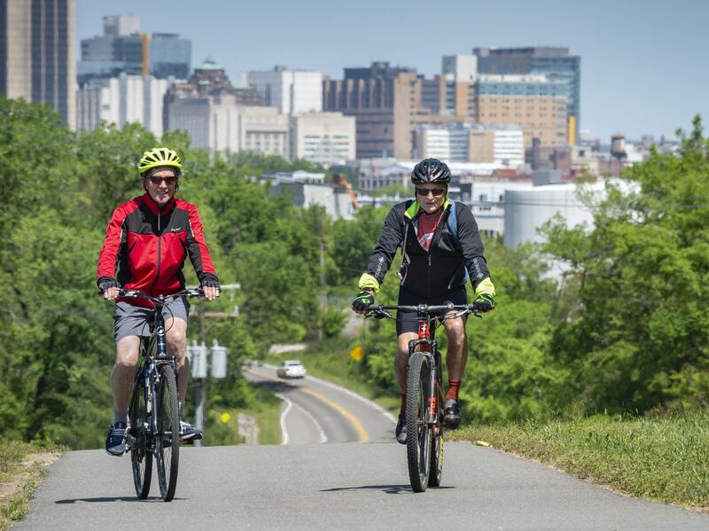Nelson Gustin of Winchester, Va. (left) and Randy Parker of Louisa, Va. ride the Virginia Capital Trail just east of downtown Richmond. 