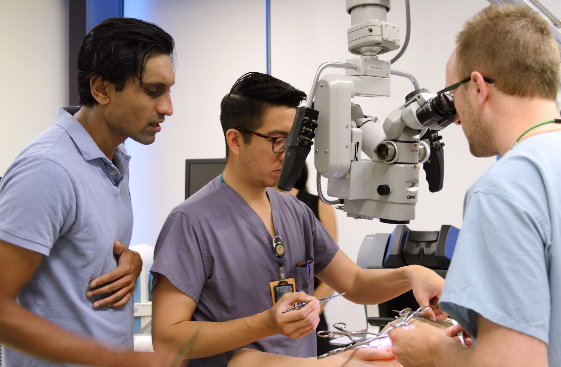 Santosh Kale, M.D., left,  watches the work of residents Franklin Lew, M.D., center; and Jonathan Miller, M.D., right. 
