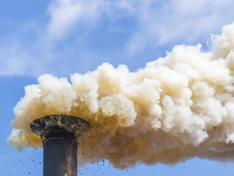 Smoke billowing from a smoke stack.