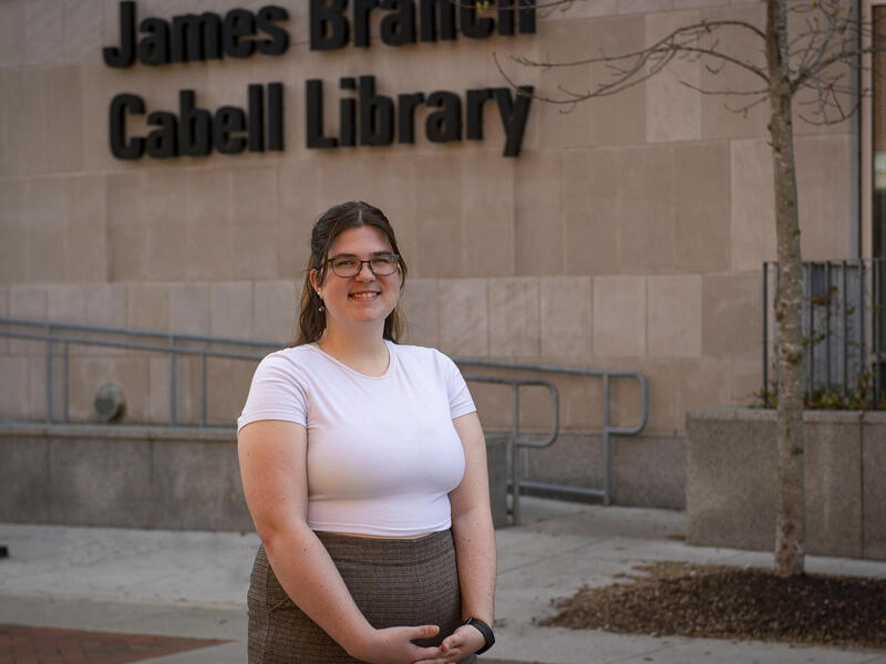 A portrait of a woman standing in front of the James Branch Cabell Library