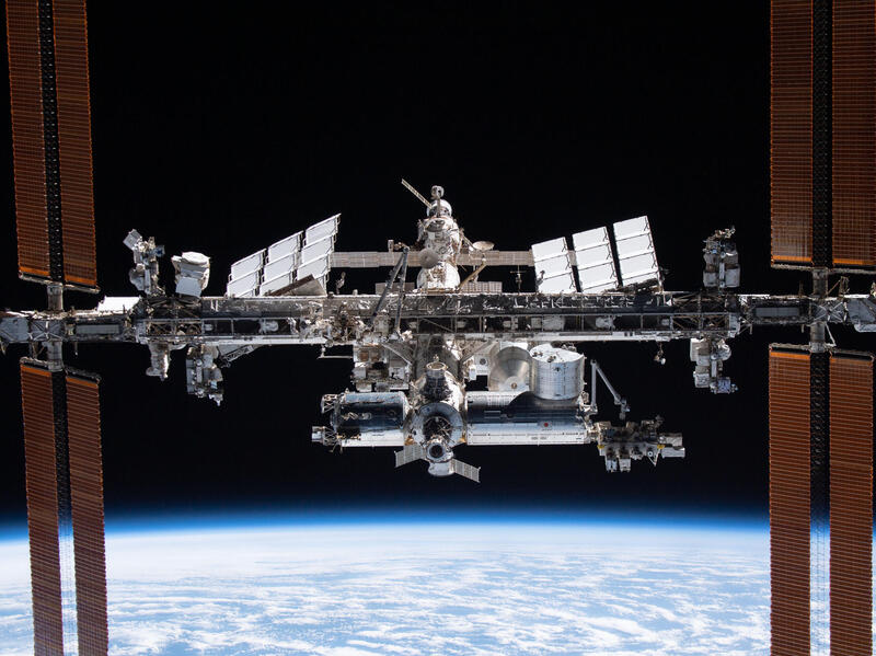 A photo of the International Space Station floating above earth. 