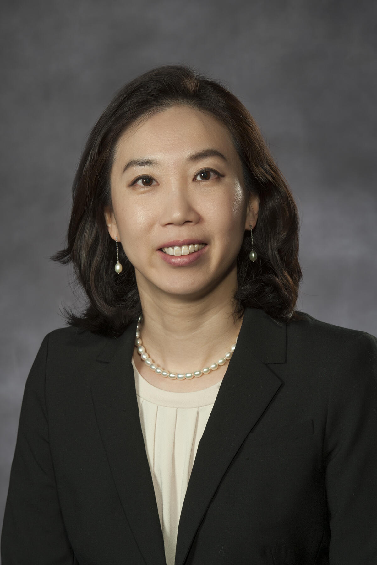 A photo of a woman from the chest up. 