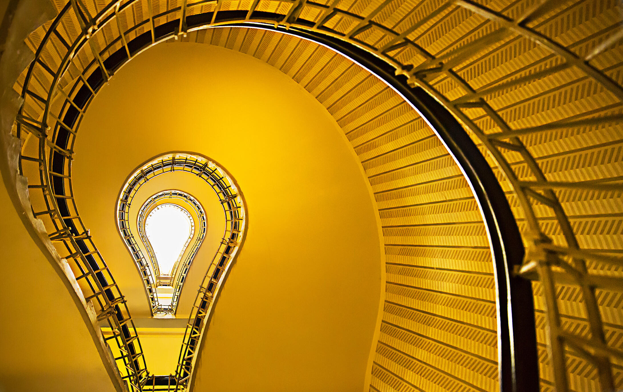 A spiral staircase in the shape of a lightbulb. 