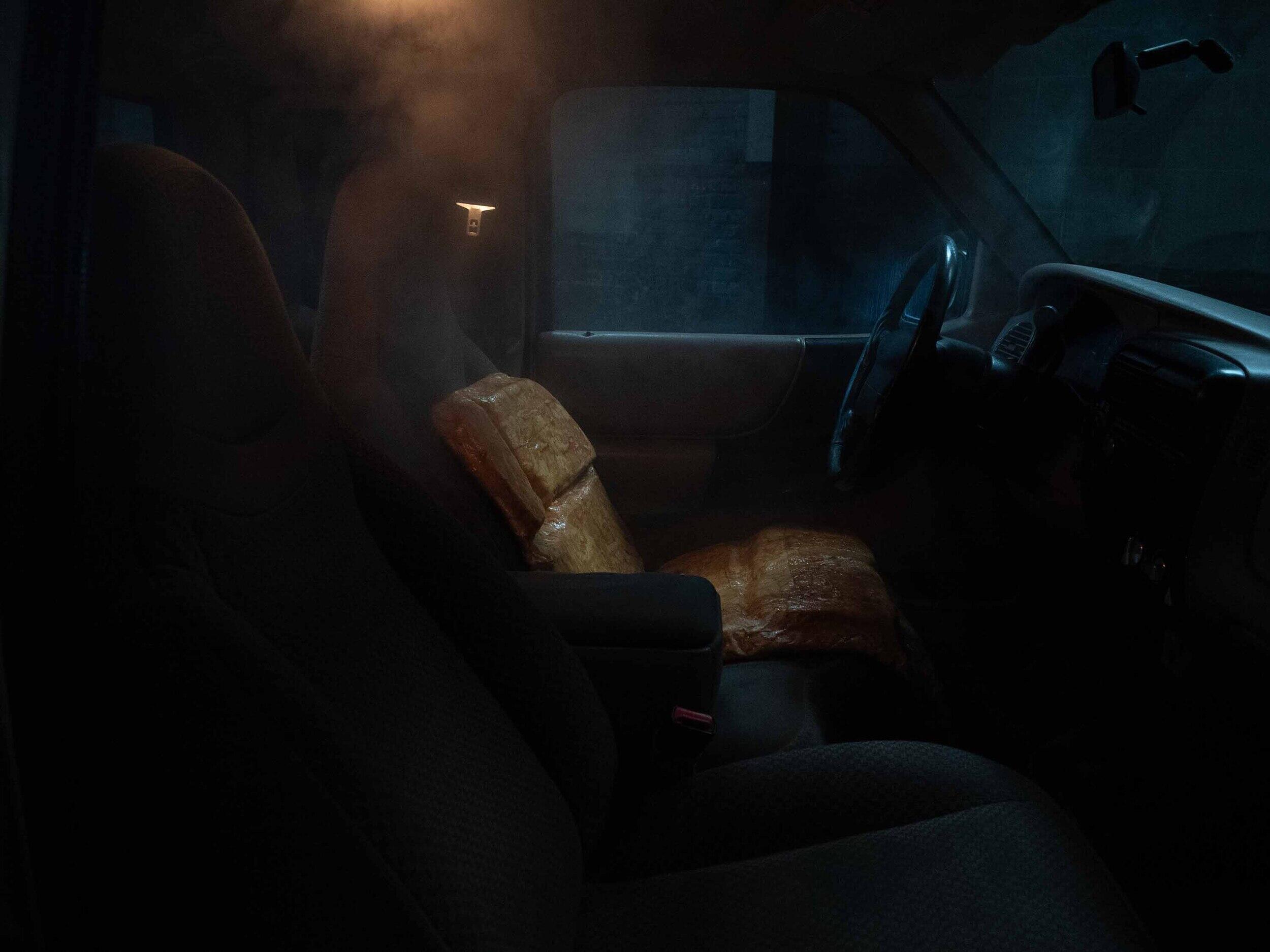 A photo of the inside of a dark car. 