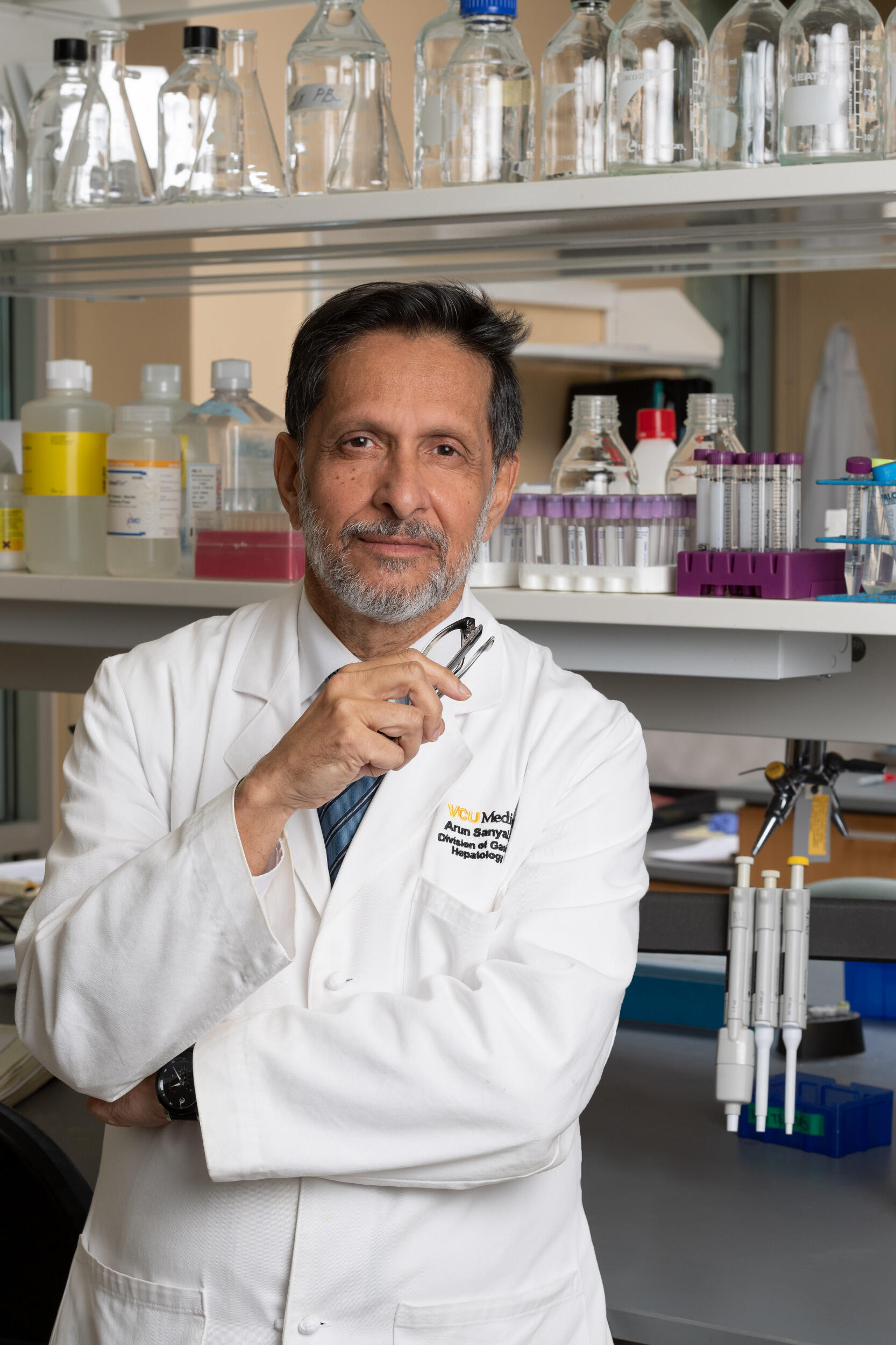 Arun Sanyal in a lab coat in a lab.