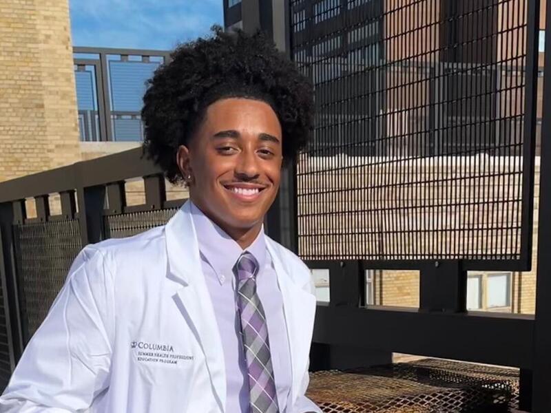 Zion Segears wearing a white lab coat