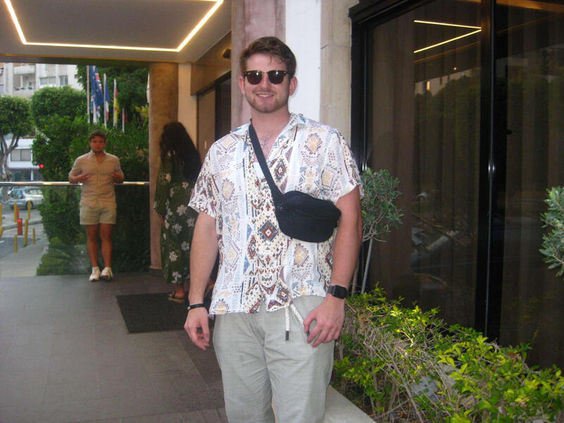 A photo of a man from the knees up. 