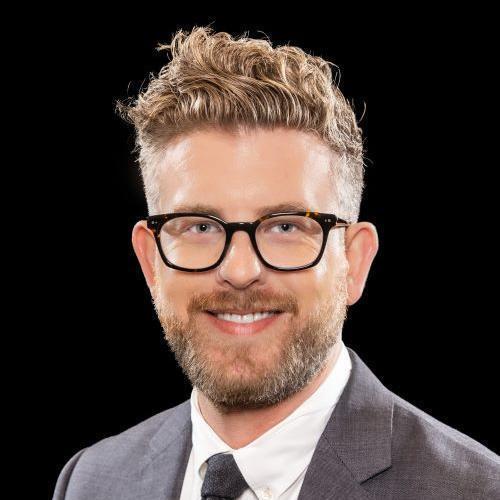 A photo of a man from the shoulders up. 