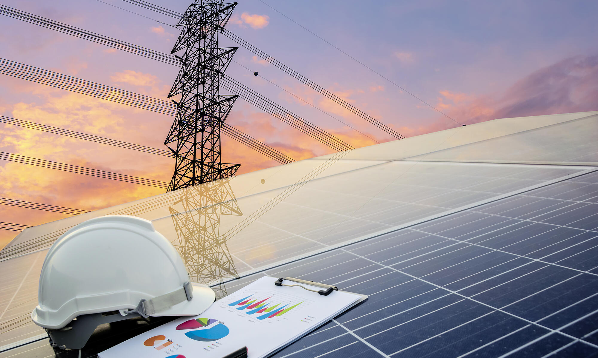 A photo of a helmet and clip board on top of a solar panel. In the background 