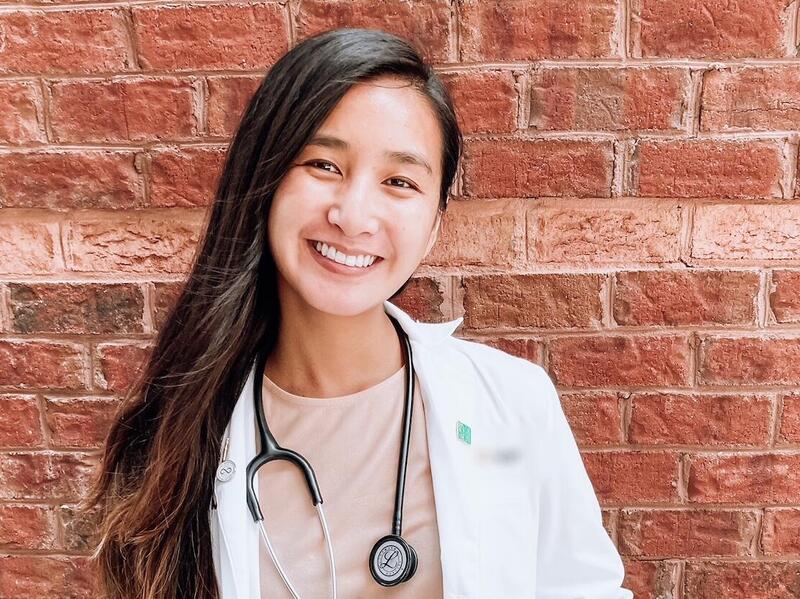 Kelly Cheung wearing a mask with a stethoscope.