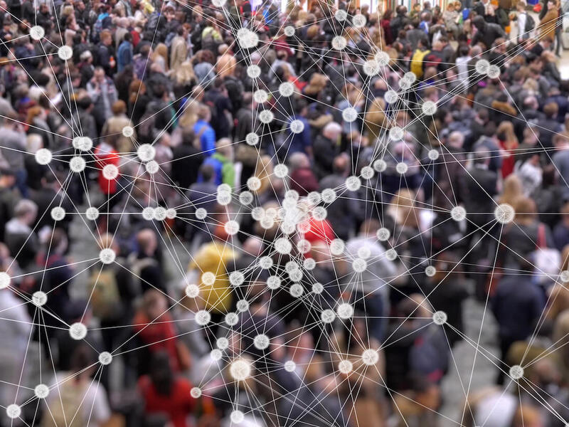 A blurry photo of a crowd of people with lines connecting dots overlaid.