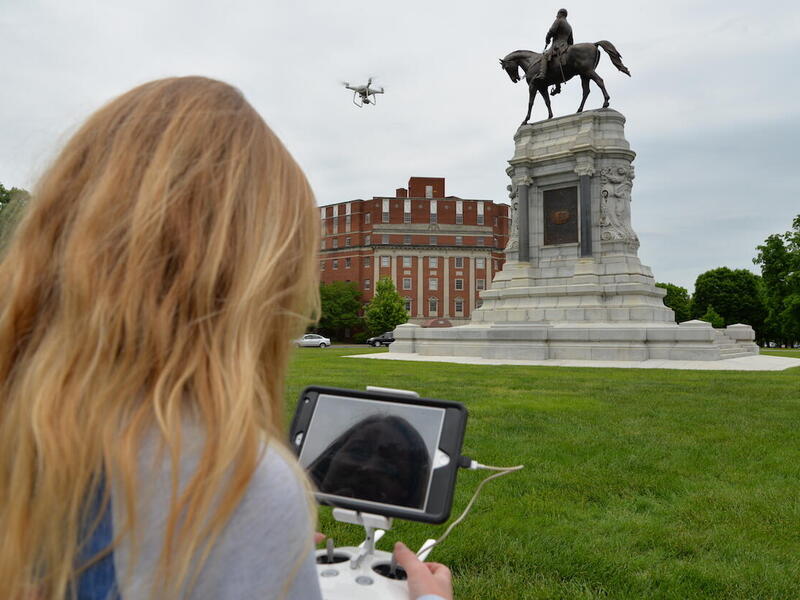 VCU alumna Ashley McCuistion pilots a drone to take photographs of the Robert E. Lee monument on Richmond's Monument Avenue.