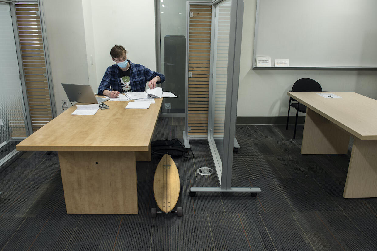A student sitting at a table in Cabell Library.
