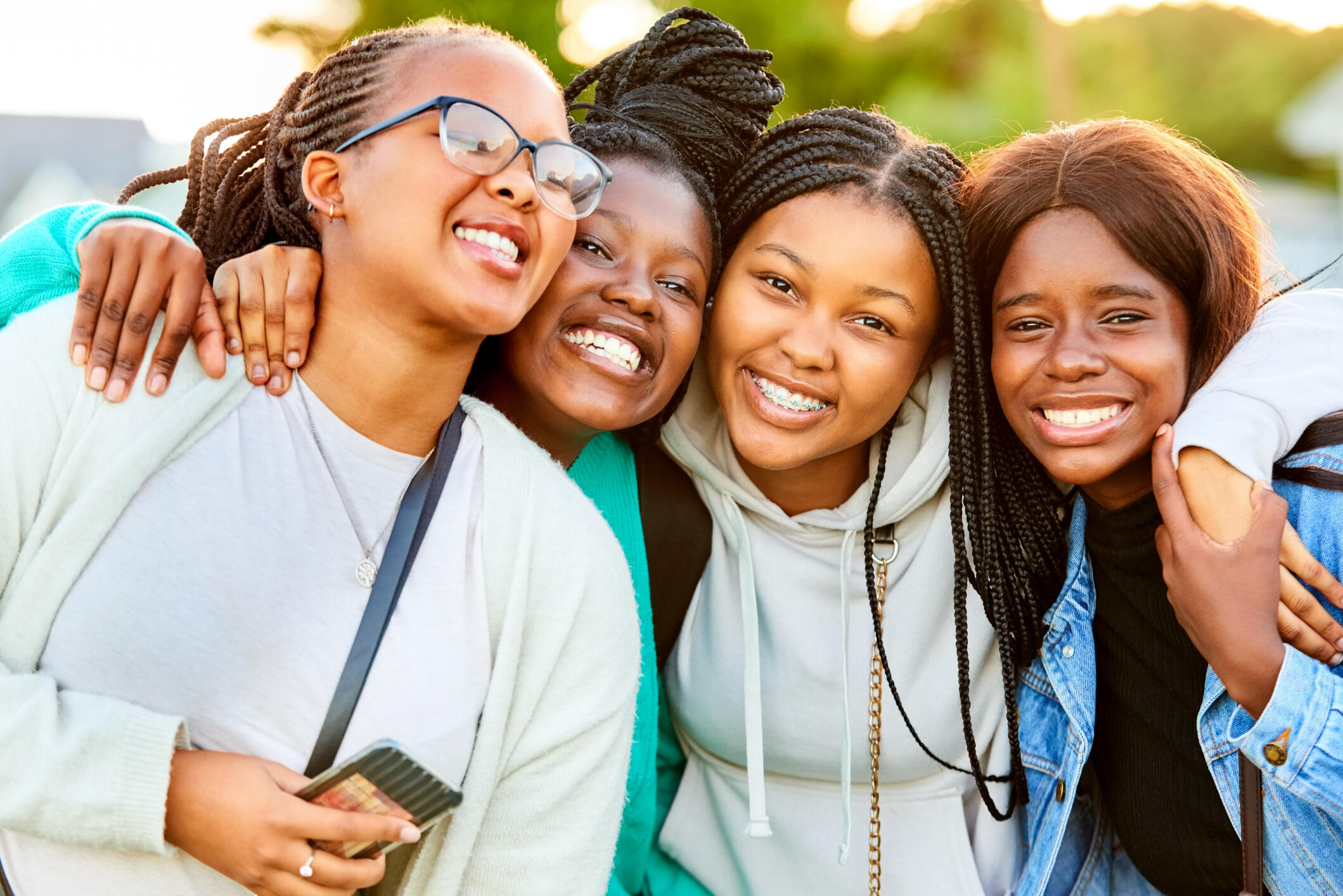 A group photo of four Black girls smiling. 