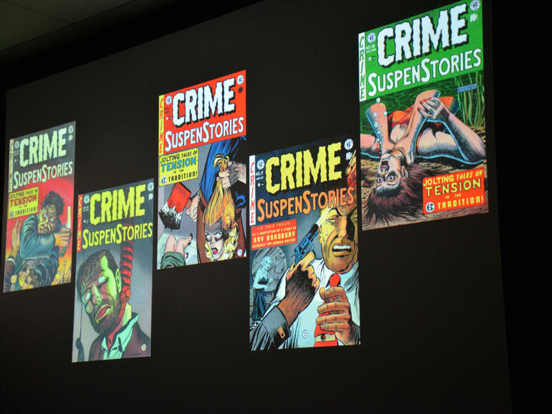 Four covers of editions of Crime SuspenStories are displayed on a screen during a presentation.
