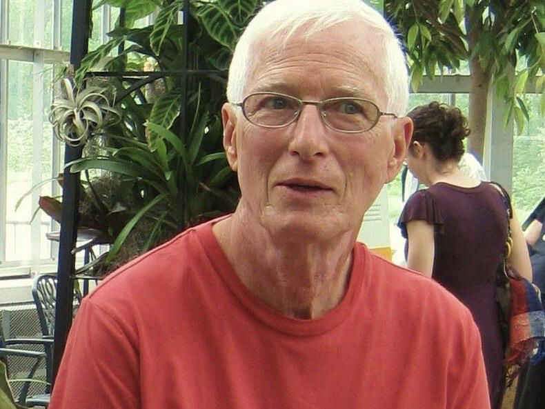 A man in a pink-colored shirt.