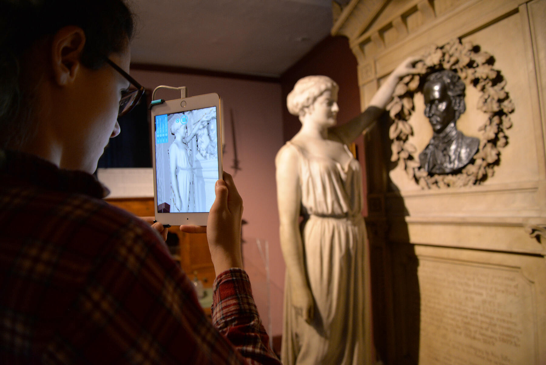 Brenna Geraghty, lab manager of the Virtual Curation Laboratory, 3-D scans the Actor’s Monument to Poe from 1882 to 1884.
