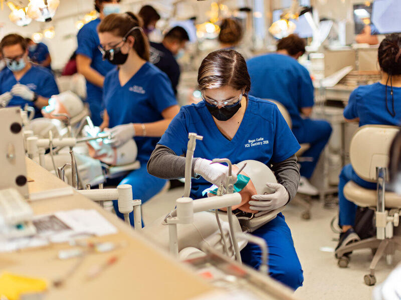 A photo of dental students working on patients 