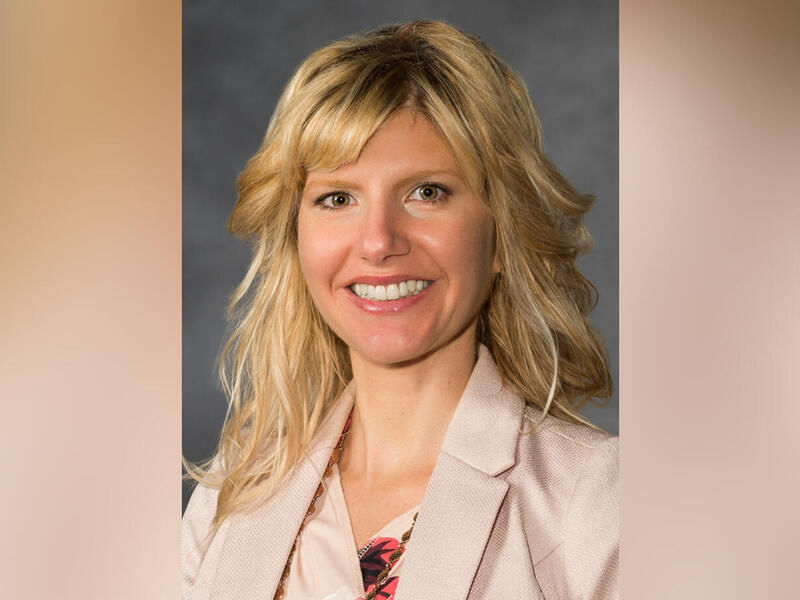 A photo portait of a woman from the shoulders up. 