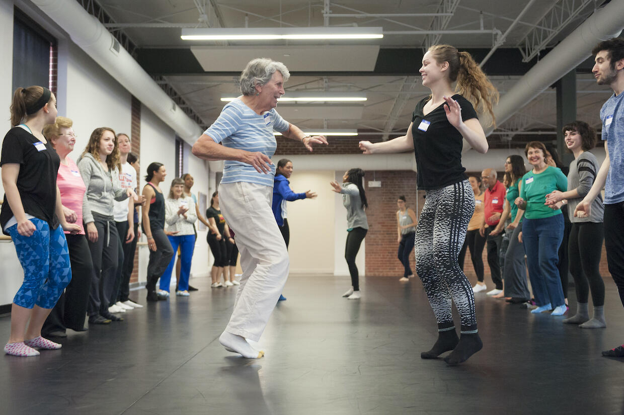 Dorothy Schoeneman, left, dances down the soul train line with Nicole Anderson