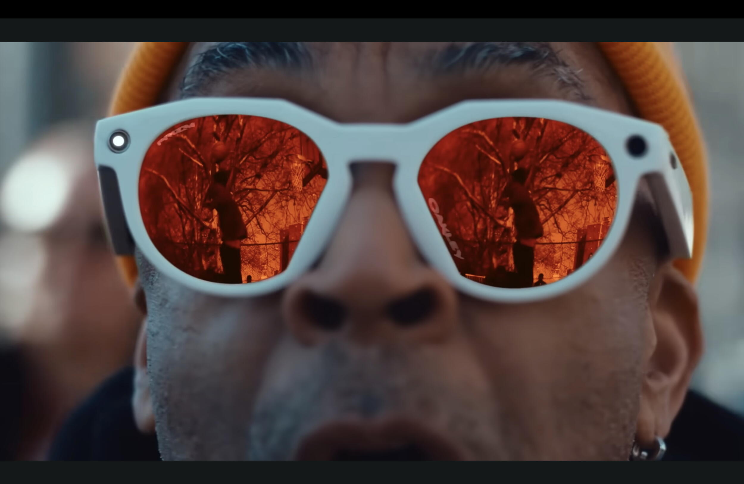 A close up photo of a man wearing white sunglasses. 