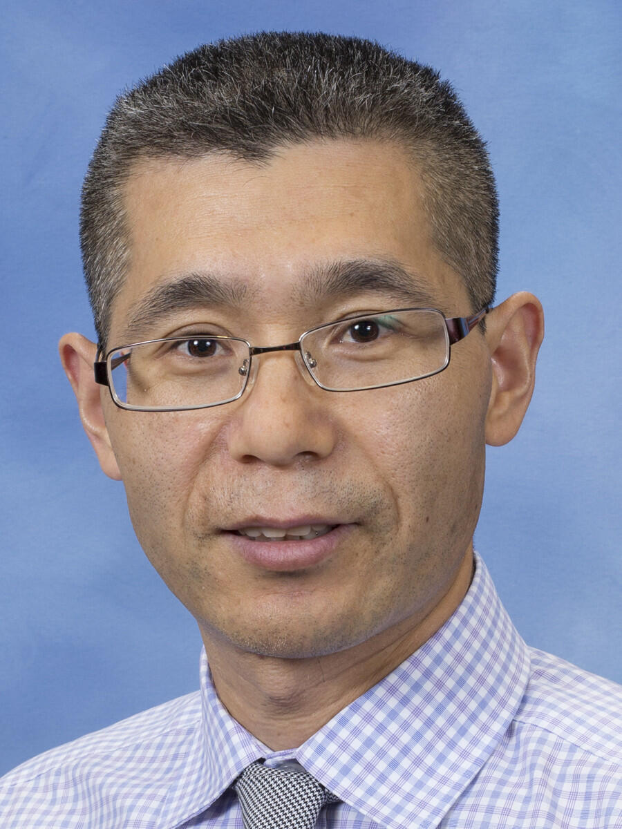 Man in light shirt and tie.