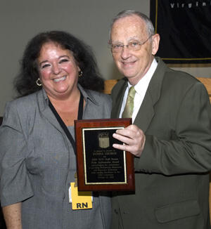 Donna George of VCU Health System Transplant Surgery accepts her Pride Ambassador award from VCU President Eugene P. Trani. Photo by Melissa Gordon, VCU Communications and Public Relations

