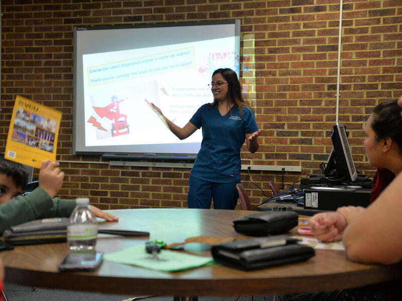 Laura Choque, a student in the VCU School of Dentistry, speaking to a group of people in a classroom.