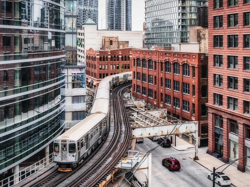 above-ground subway train snakes its way through the city
