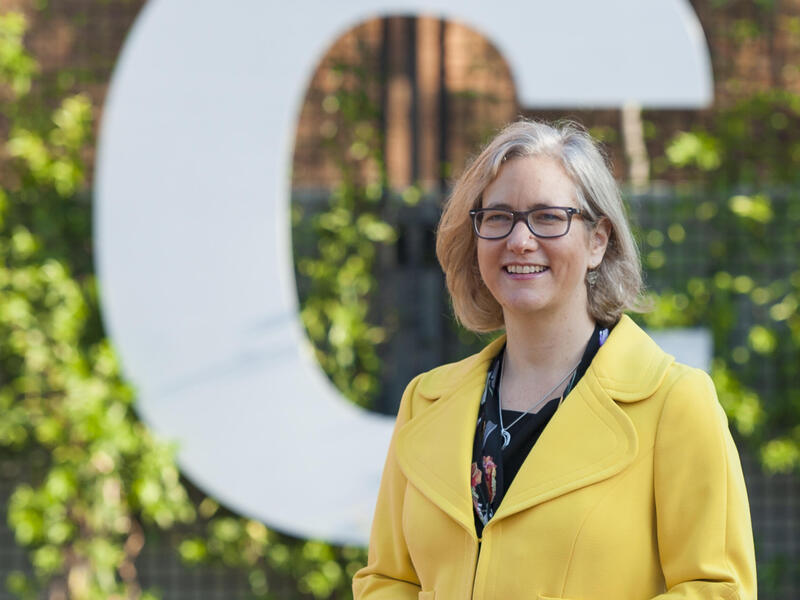 Beth Angell, Ph.D. standing in front of a \"VCU\" letter sign 