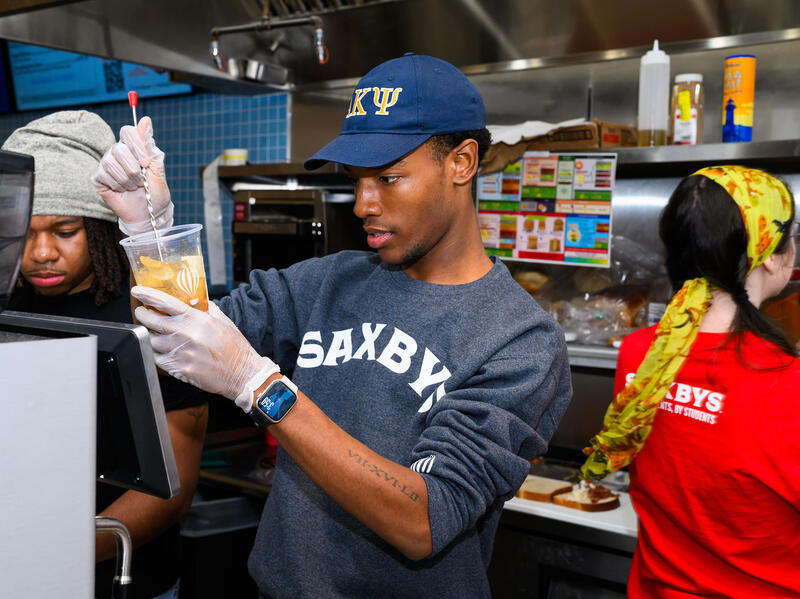 A photo of students working in a professional kitchen. 