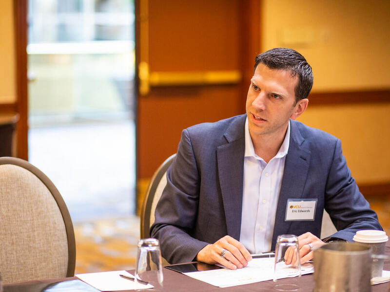 Eric Edwards seated at a table.