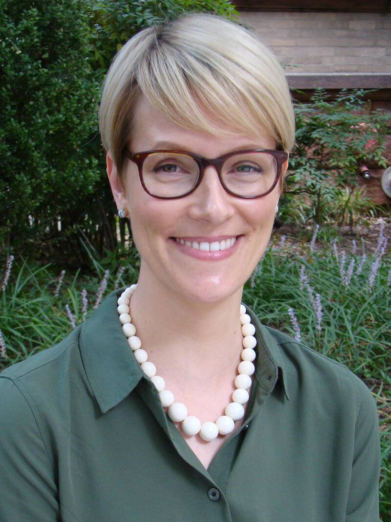 A porait of a woman from the chest up. 