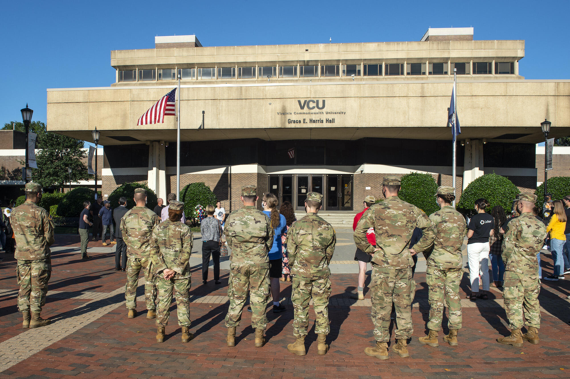 Students in military fatigues stand at a 9/11 anniversary event.