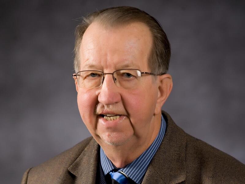 A photo of a man from the shoulders up. 