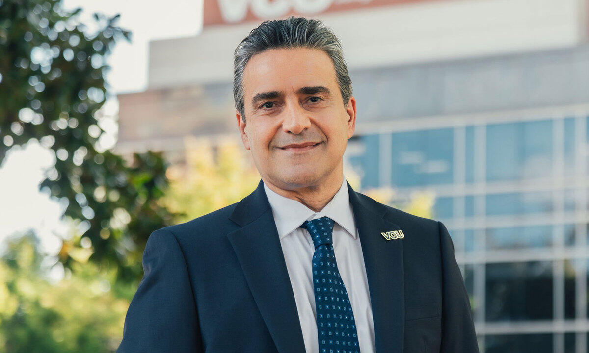 A photo of a man in a suit from the chest up. 