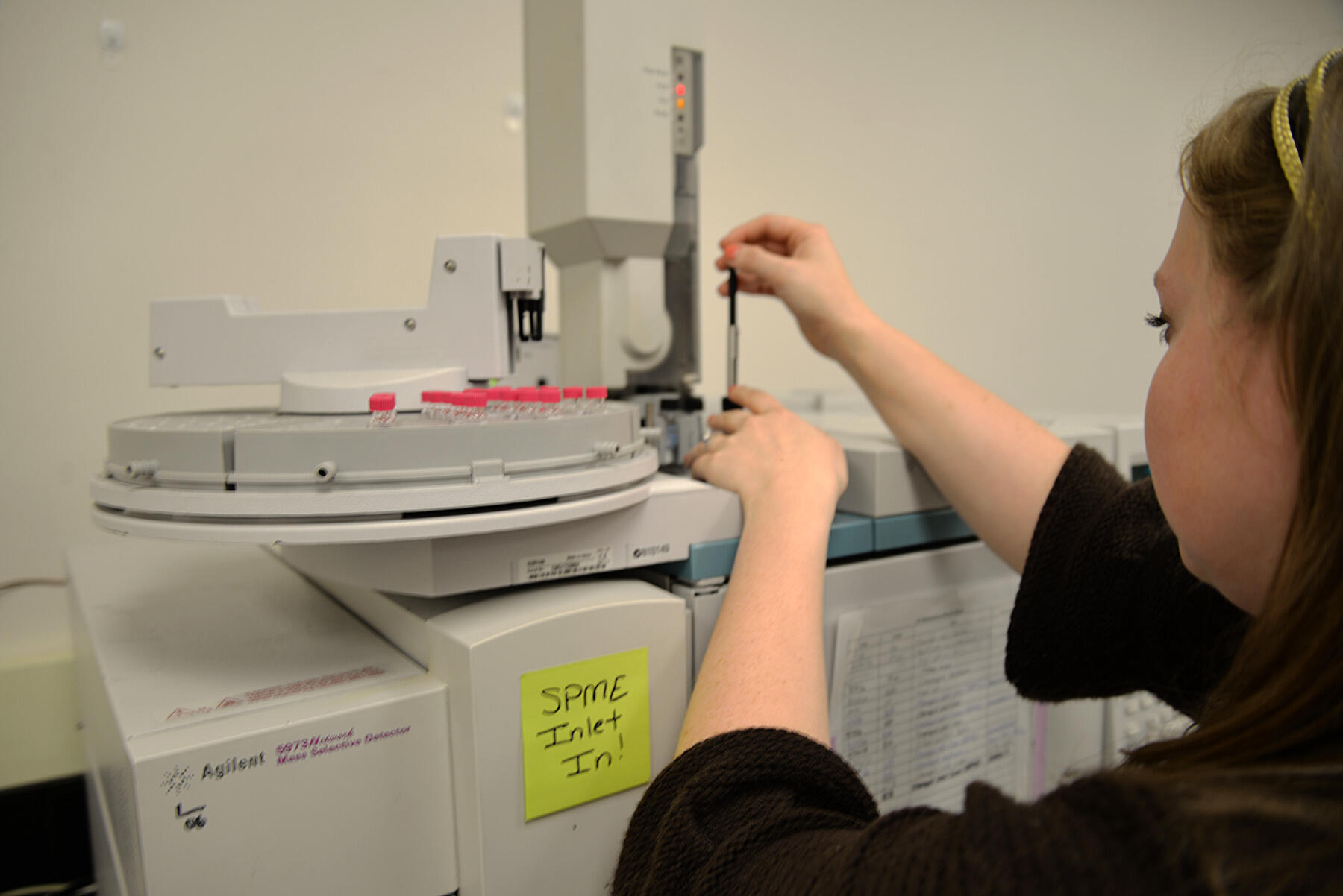 Karen Butler, who received her master’s degree in forensic science from VCU in May and helped developed the e-cigarette testing model, performs a Gas Chromatography Mass Spectrometry analysis on substances derived from a vape cloud.
