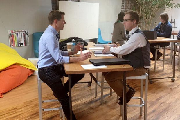 Set designer Tony Cisek (left) meets with student James Nicholas.