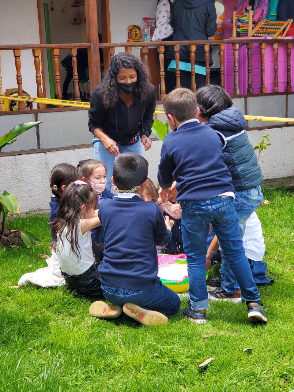 A woman standing in front of several children 