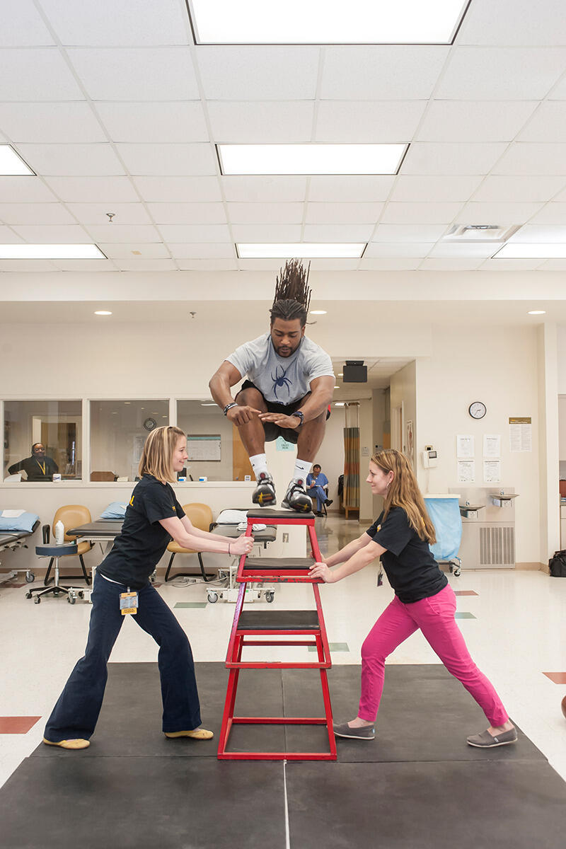 Hightower lands a vertical jump of 46 inches during a session with Harwood (left) and Moran (right)