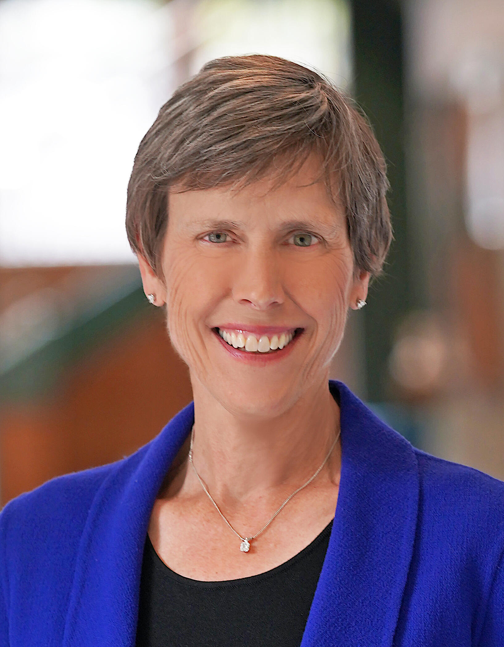 Headshot of Dr. Jean Giddens with a blurred background.