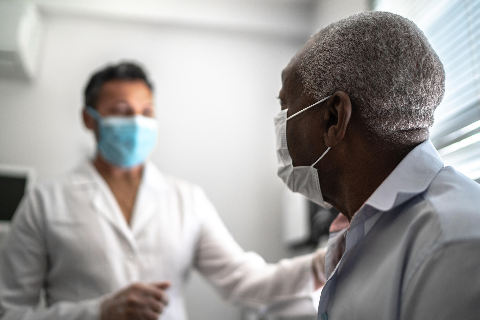 Black man wearing a mask at the doctor's office