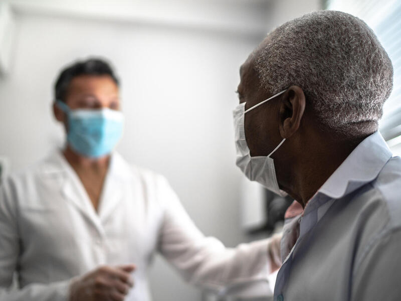 Black man wearing a mask at the doctor's office