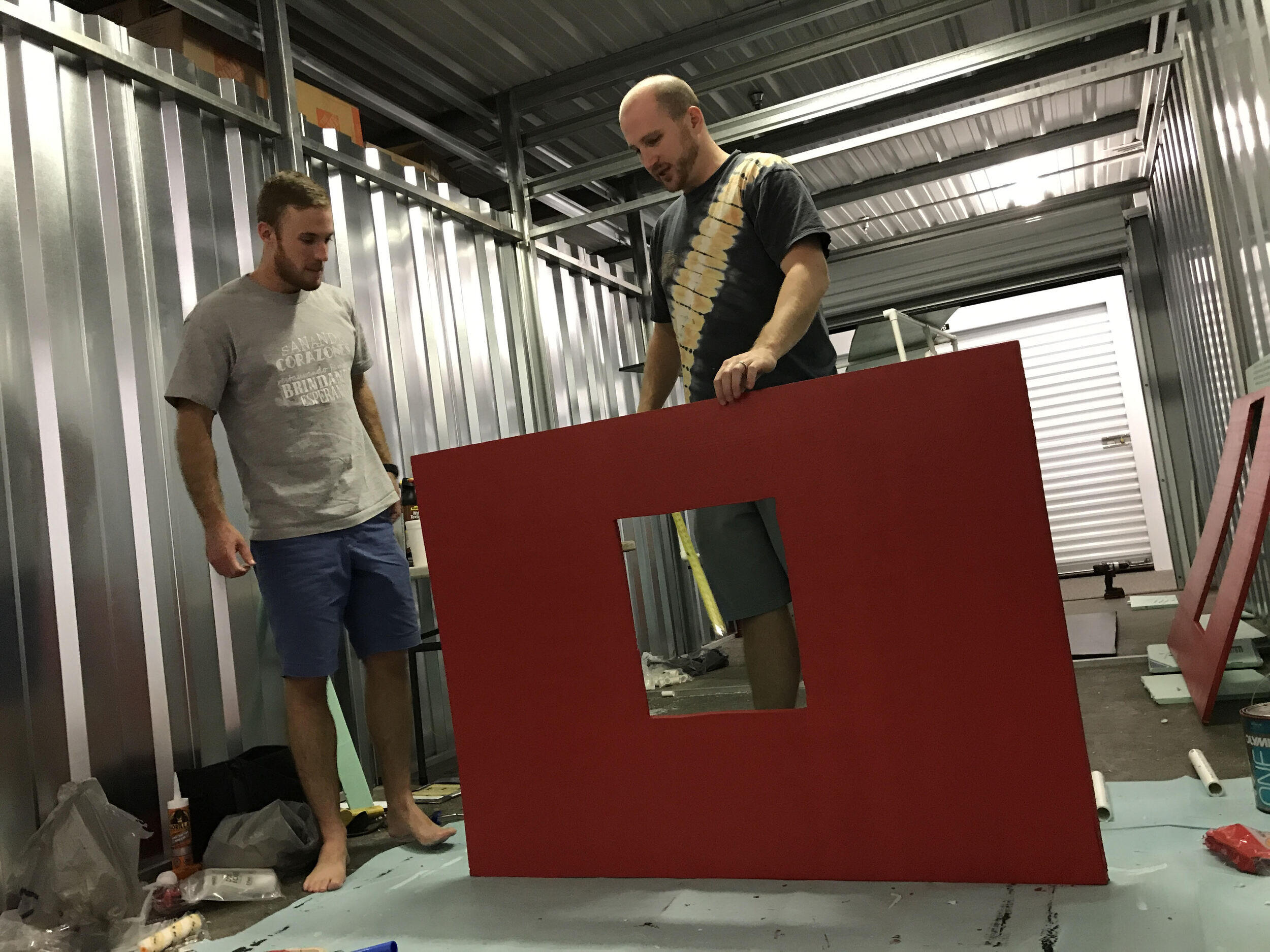 Alex Schloe, a fourth-year medical student, and Hunter Simpson, VCU School of Dentistry alumnus and head builder of the project, plan out how to piece the barn together. (Photo credit: Courtesy of Sarah Simpson)